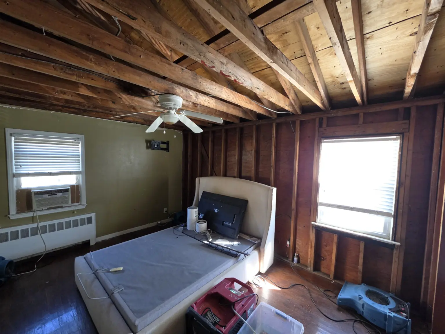 Bedroom undergoing insurance-funded roof and ceiling repair